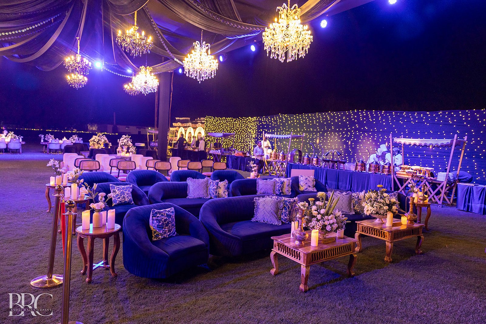 A reception at night beneath a lit canopy