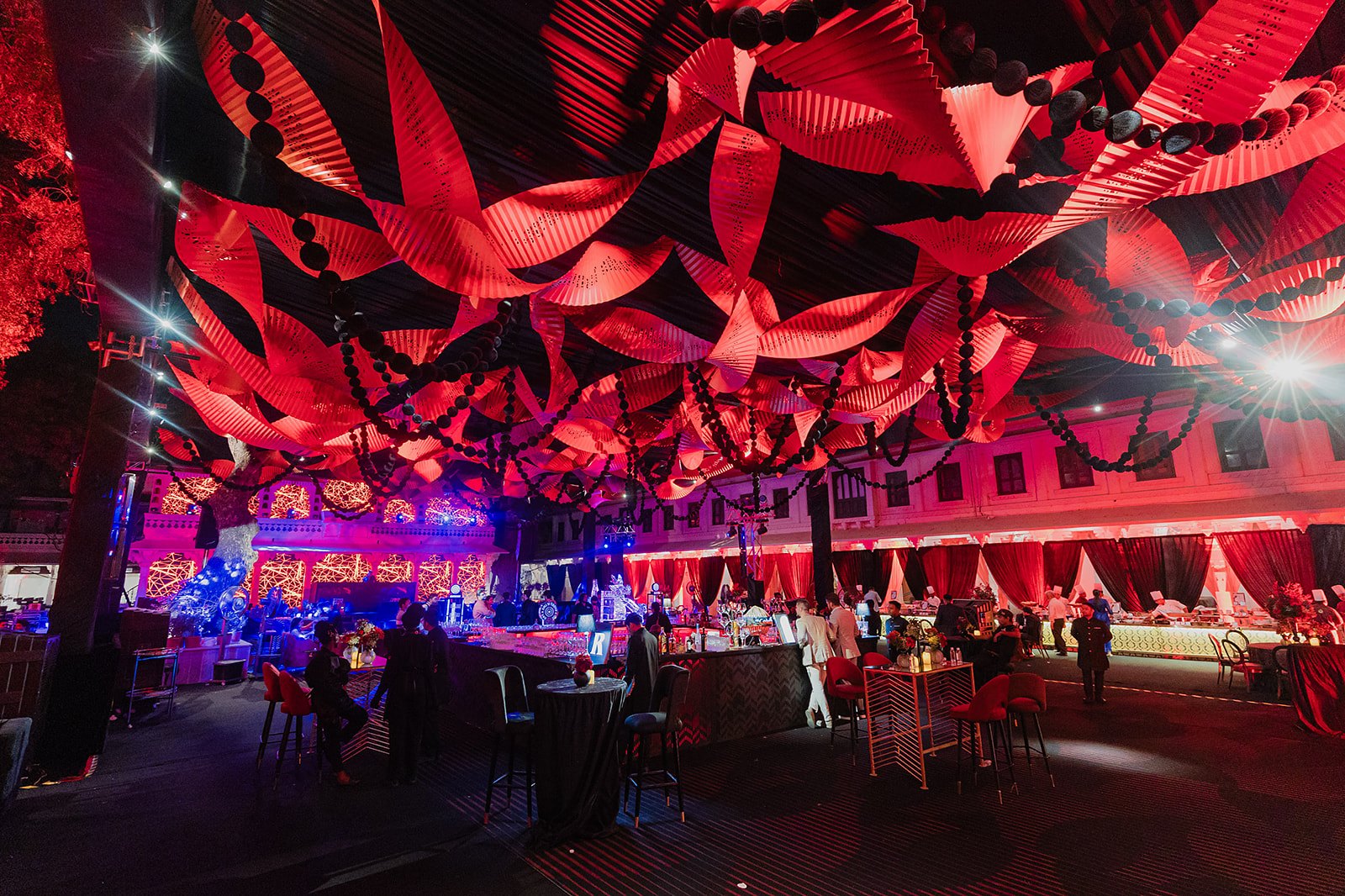 A red installation over the floor at night
